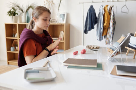 Canva – Girl Sitting by the Table