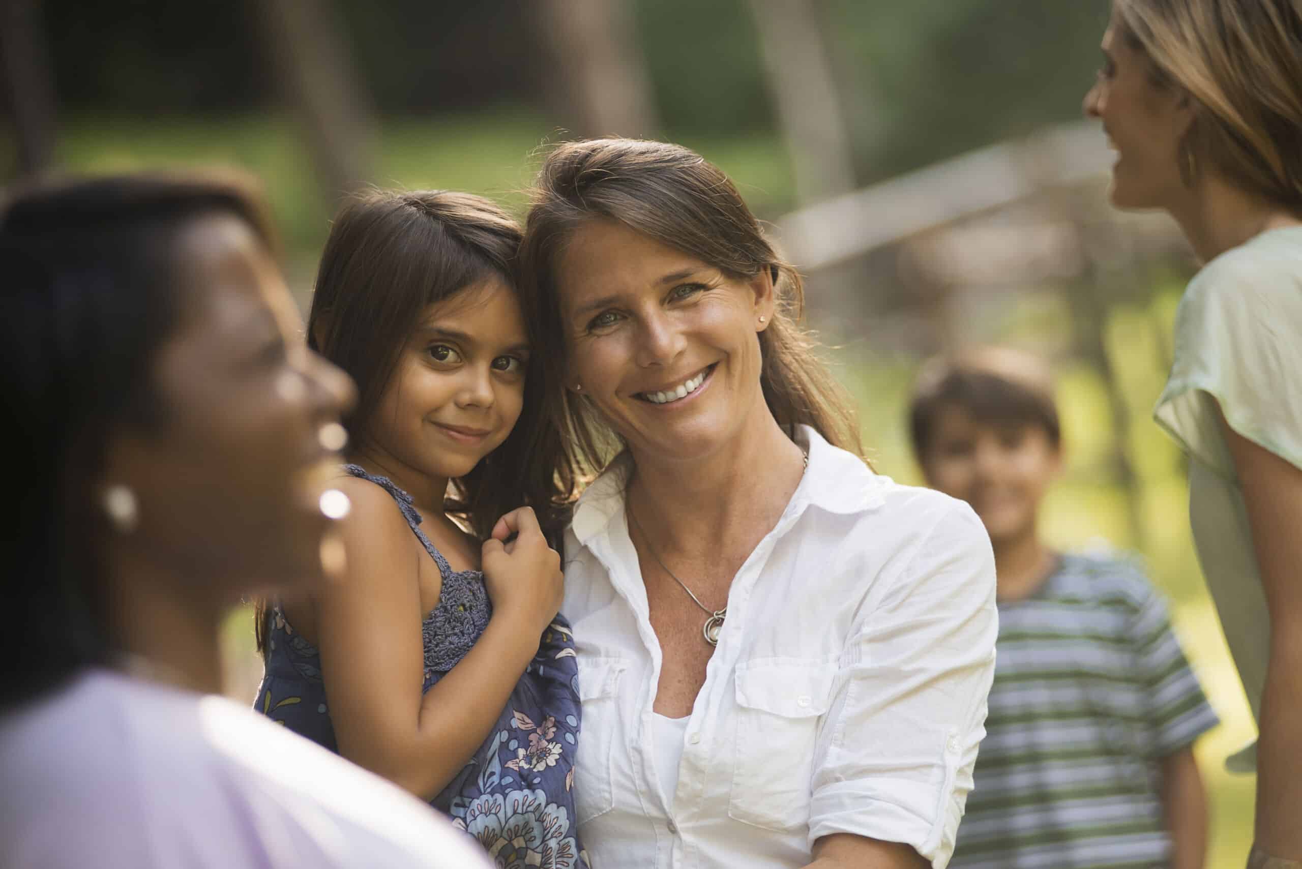 A family,USA,A group of women and children outdoors, laughing and smiling.